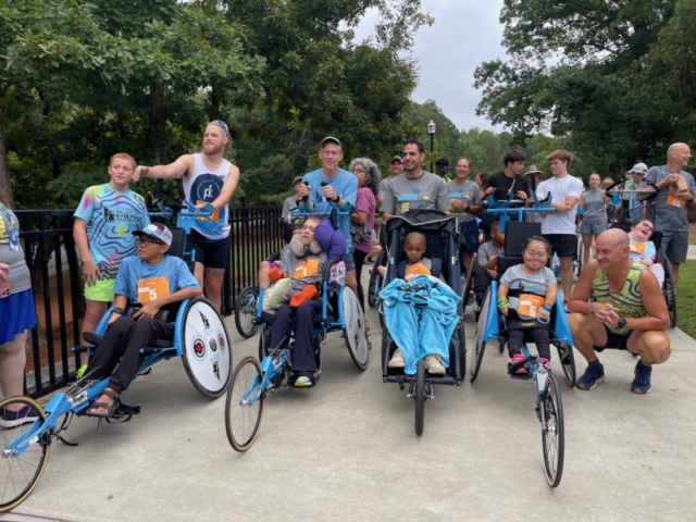 Group of racers in racing wheelchairs lining up before the race