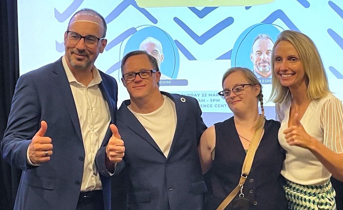 Dr. Espinosa giving a thumbs up with two self-advocates and a woman