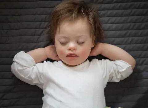 Young child with Down syndrome sleeping