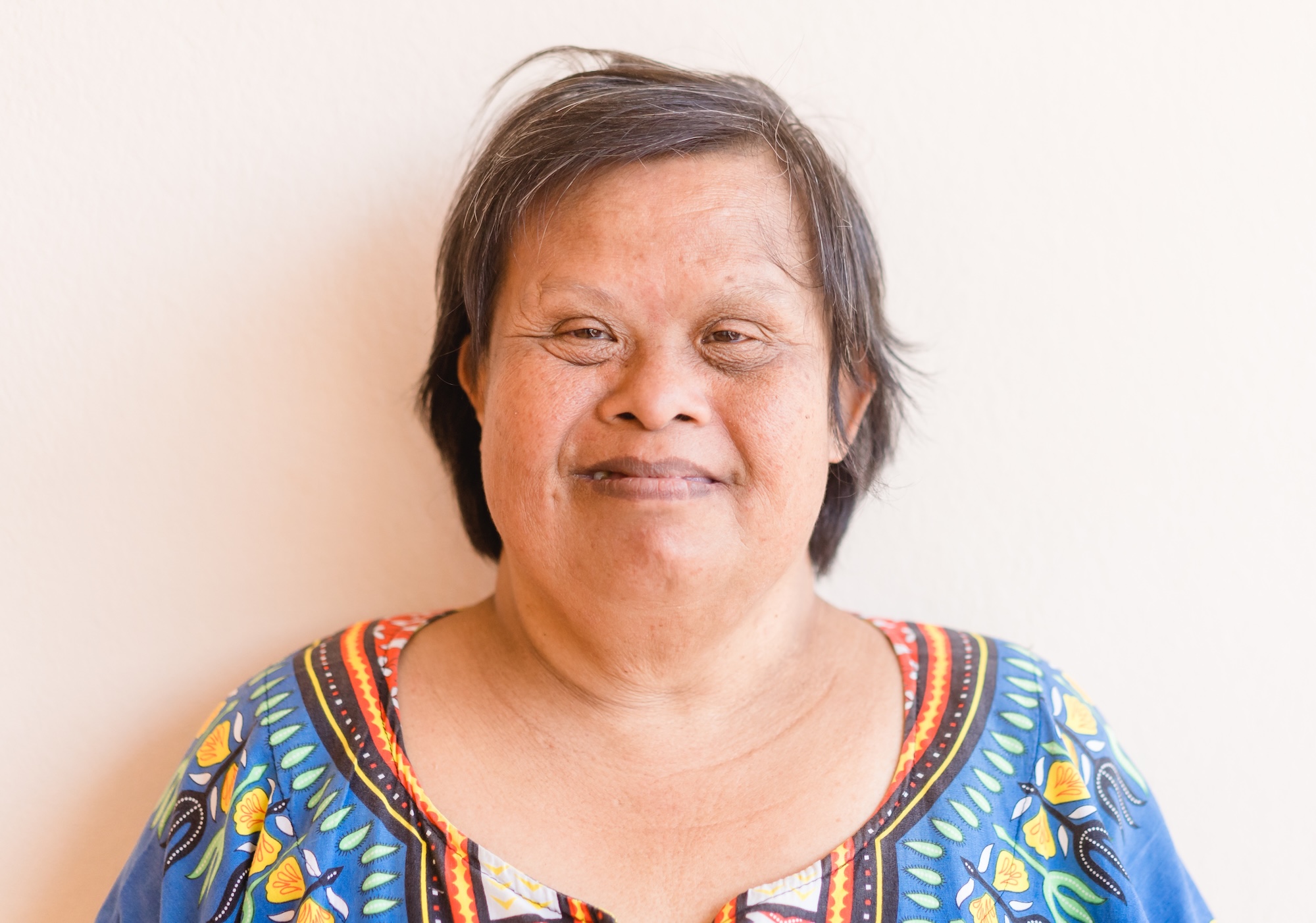 Older woman with Down syndrome smiling