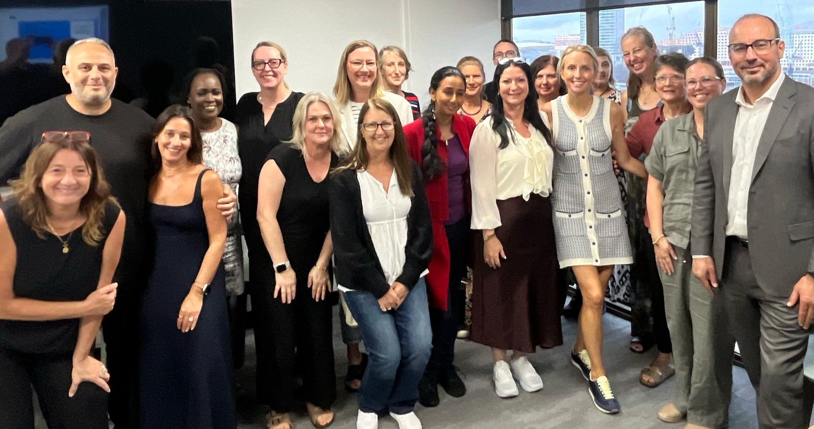 Dr. Espinosa posing with a group of people in Australia