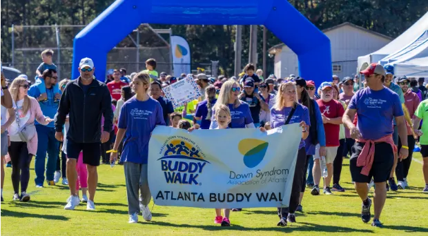 People standing at the finish line with a sign