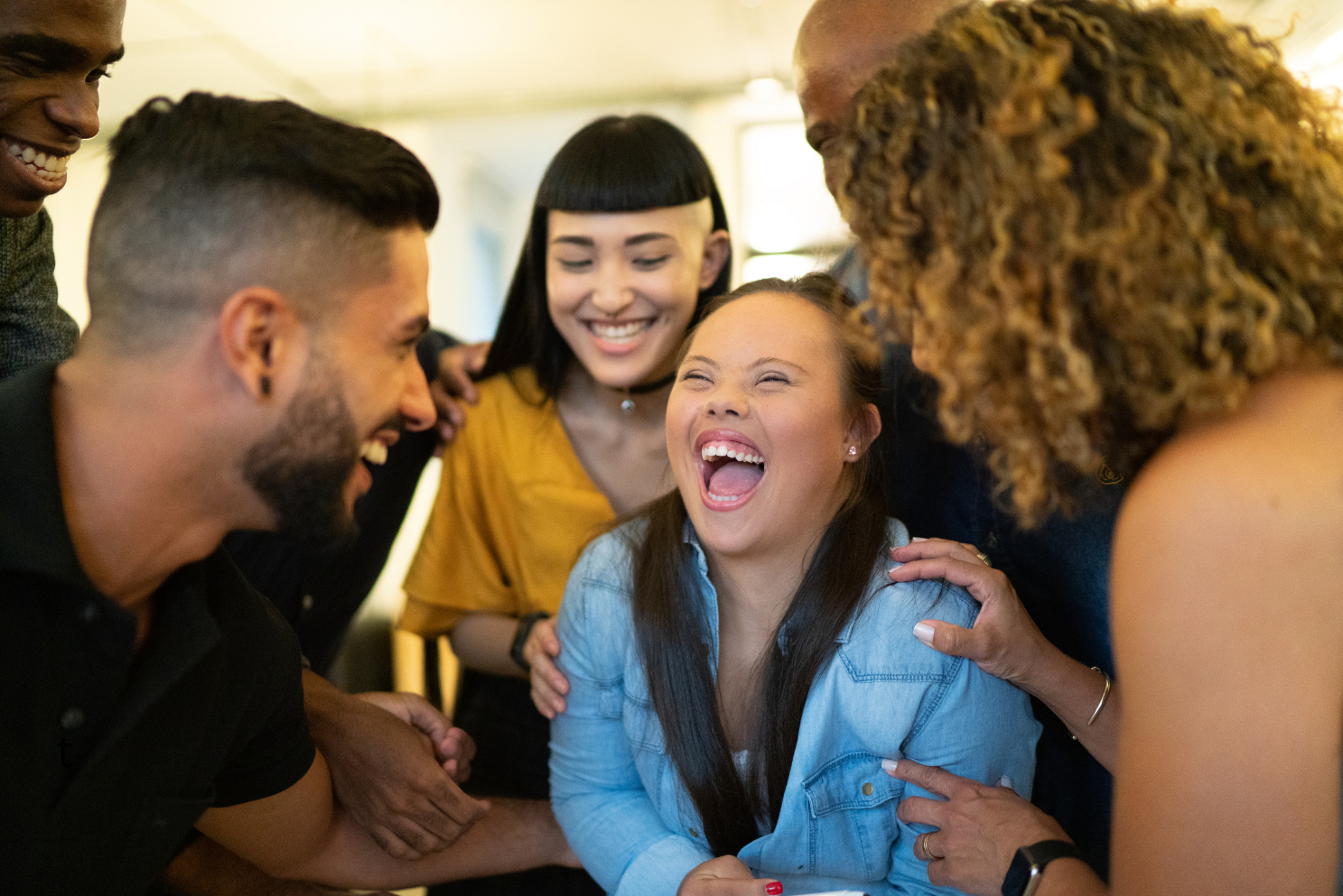 Young woman with Down syndrome laughing with a group of friends