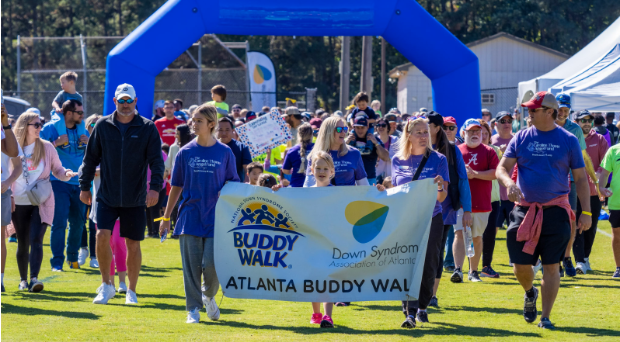 People standing at the finish line with a sign