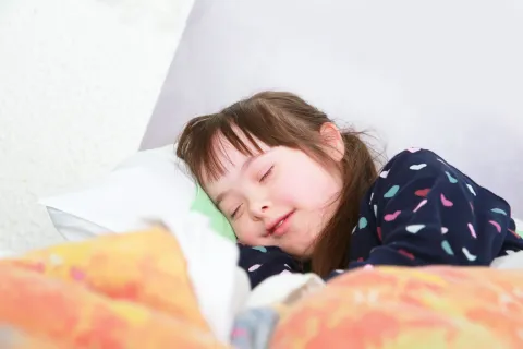 Child with Down syndrome sleeping