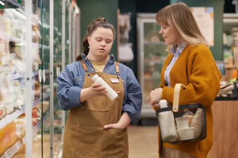 Woman with Down syndrome working in a grocery store