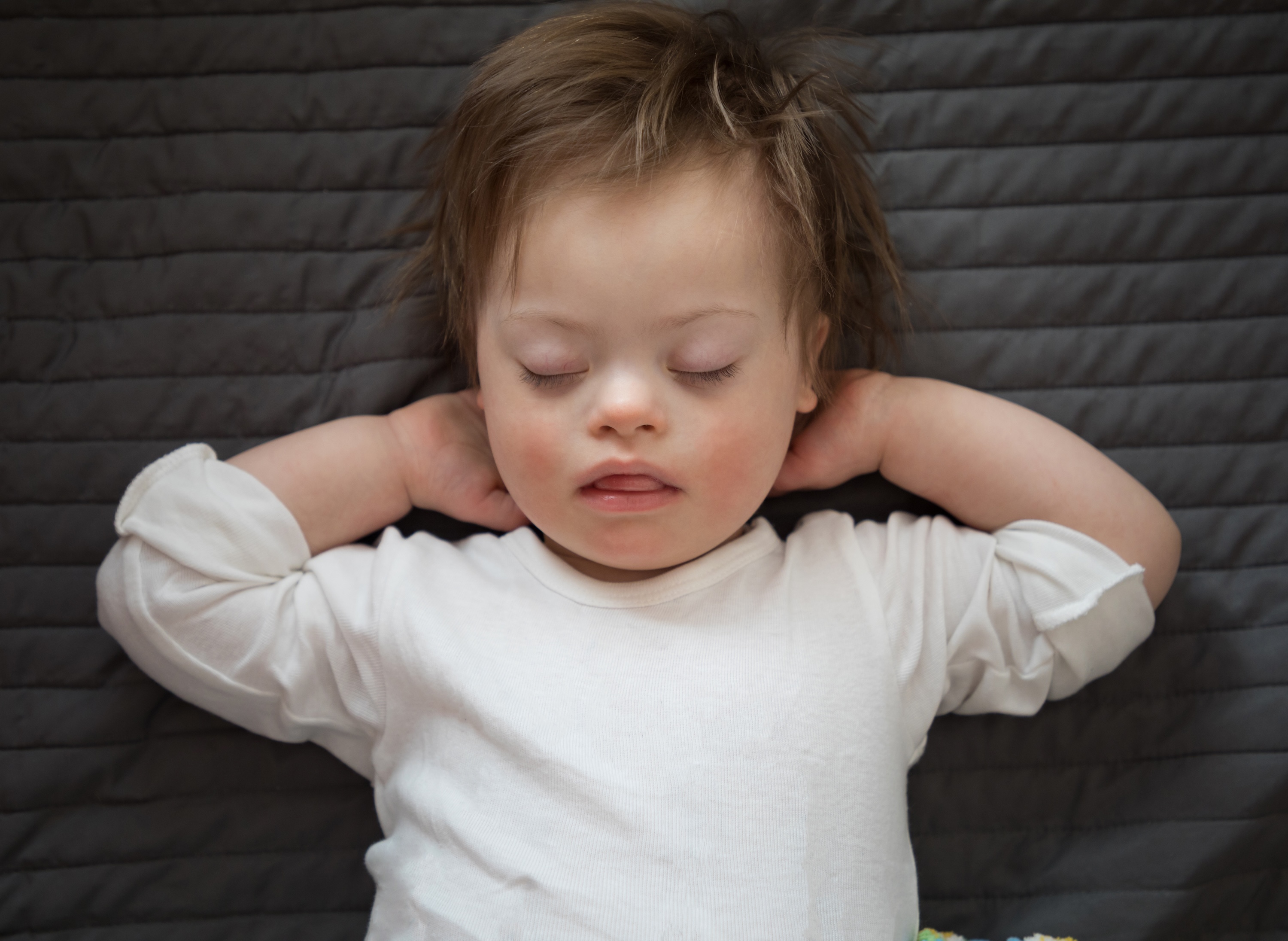Young child with Down syndrome sleeping
