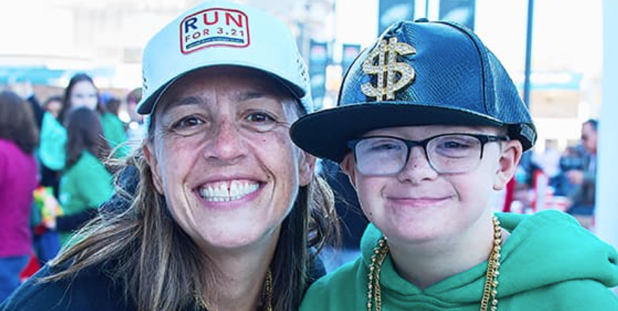 Mom and son with Down syndrome smiling