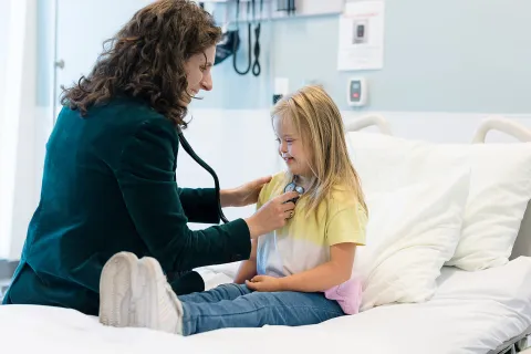 Girl with Down syndrome with a doctor